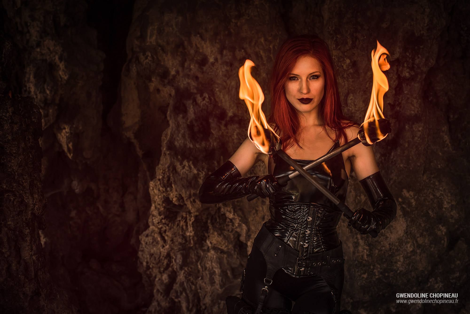 Portrait of Ariel Firestone with two fire torches