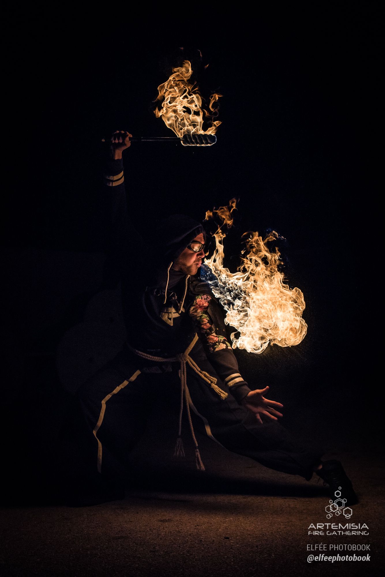 Artemisia 2018 gala: a hooded fire breather lit by his torch