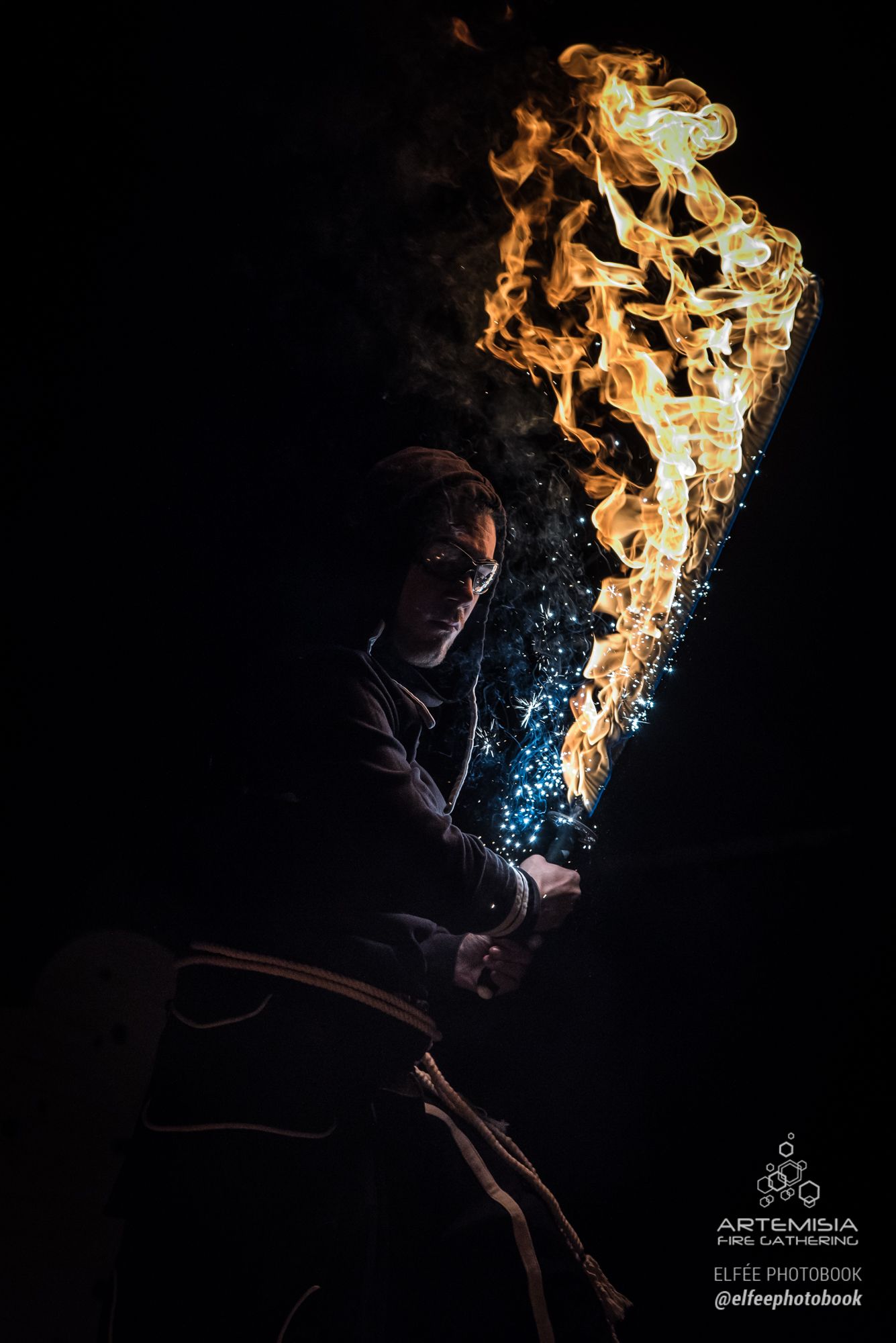 Artemisia 2018 gala: a fire katana held upright in the dark